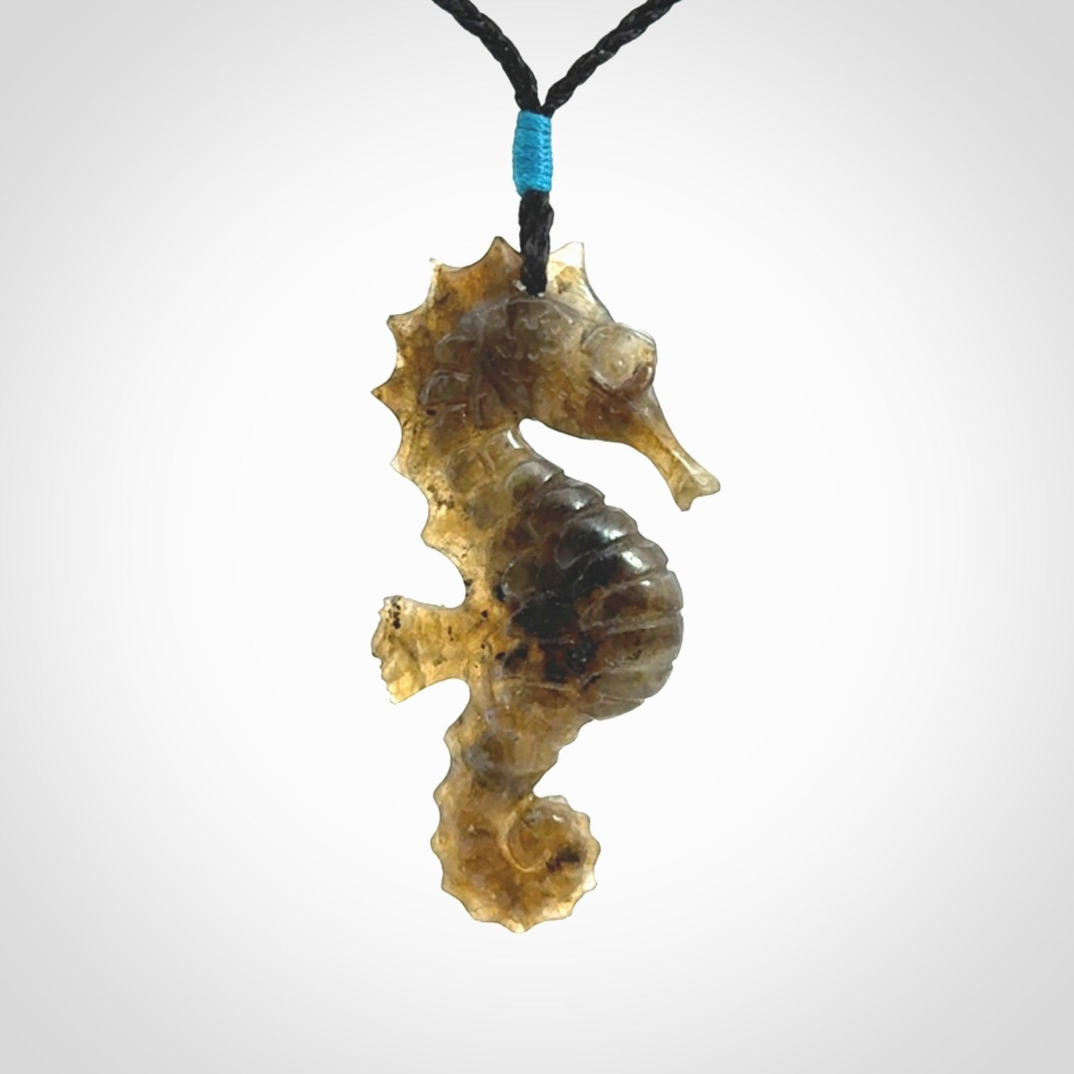 A hand carved labradorite seahorse pendant. We have carved this from beautiful labradorite and we bind them with our hand-plaited cords. The cords are a waxed polyester so they are durable and strong. We ship these worldwide with express courier anywhere in the world.