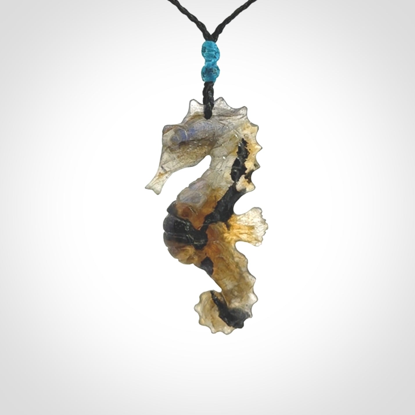 A hand carved labradorite seahorse pendant. We have carved this from beautiful labradorite and we bind them with our hand-plaited cords. The cords are a waxed polyester so they are durable and strong. We ship these worldwide with express courier anywhere in the world.
