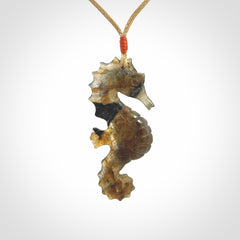 A hand carved labradorite seahorse pendant. We have carved this from beautiful labradorite and we bind them with our hand-plaited cords. The cords are a waxed polyester so they are durable and strong. We ship these worldwide with express courier anywhere in the world.