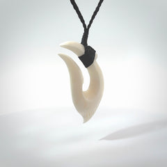 Hand carved cow bone hook pendant. Maori matau carving, hand carved jewellery for sale online.