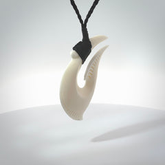 Hand carved cow bone hook pendant. Maori matau carving, hand carved jewellery for sale online.