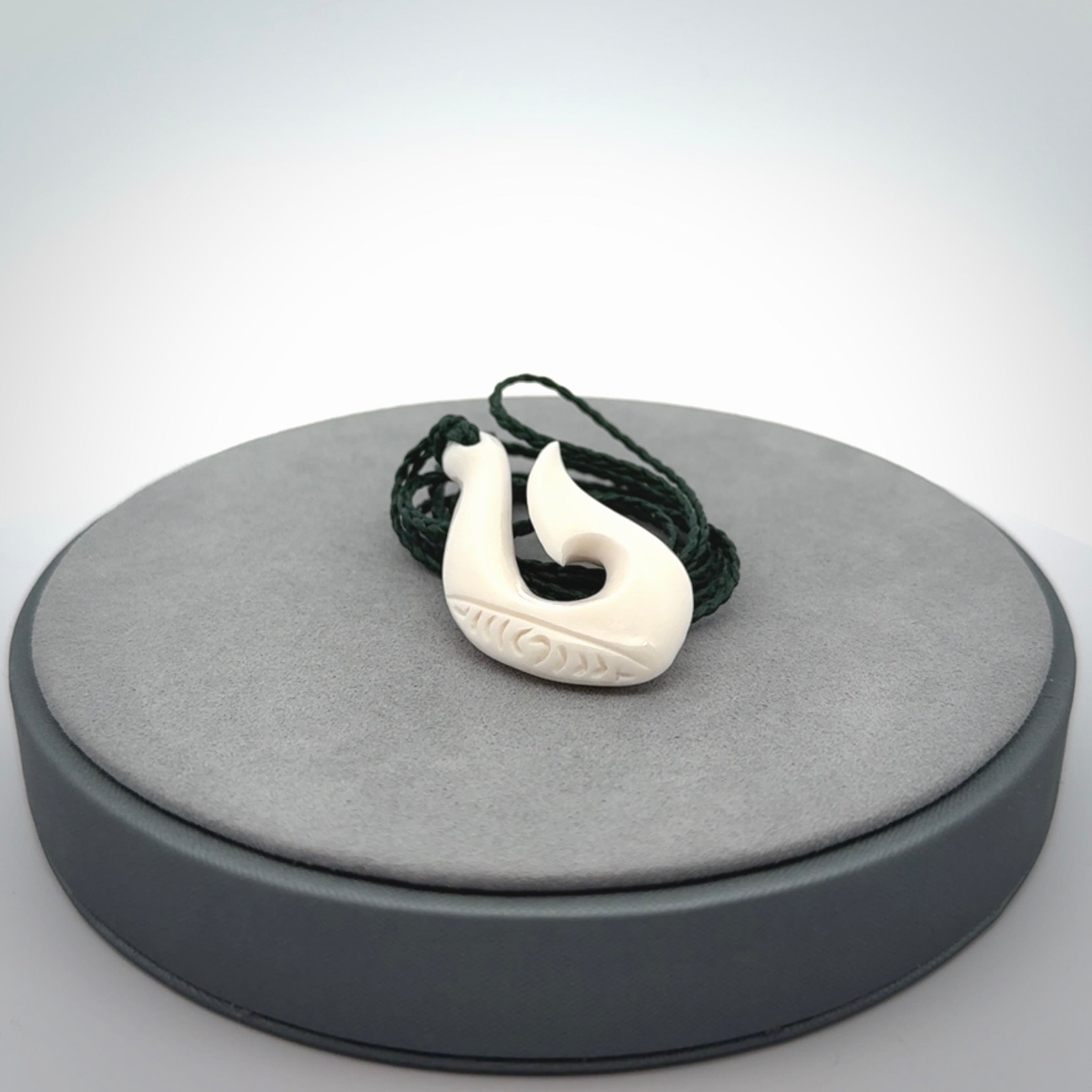 Hand carved bone hook pendants