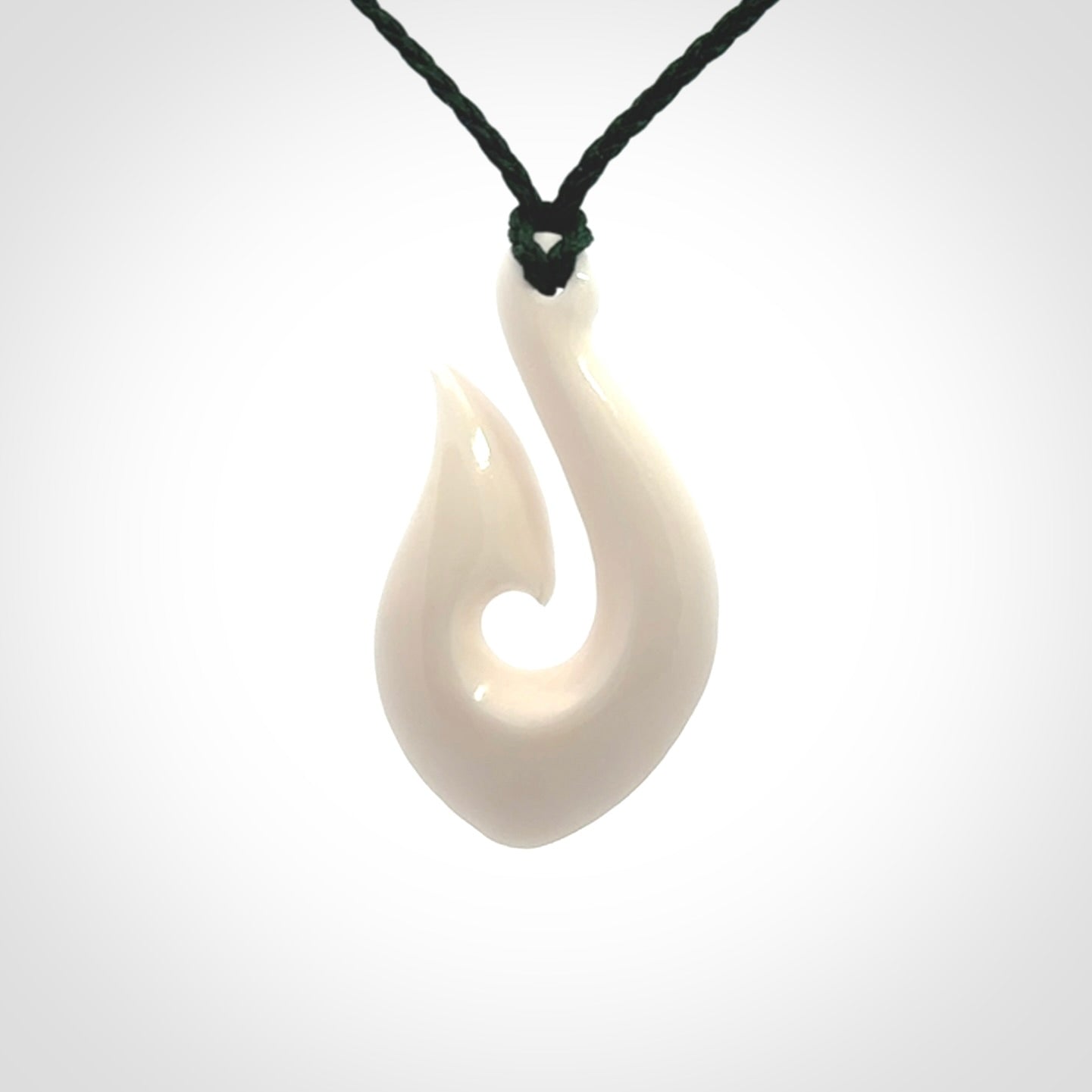Hand carved bone hook pendants