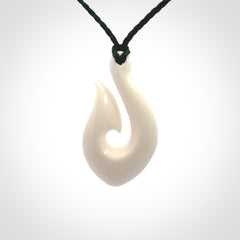 Hand carved bone hook pendants