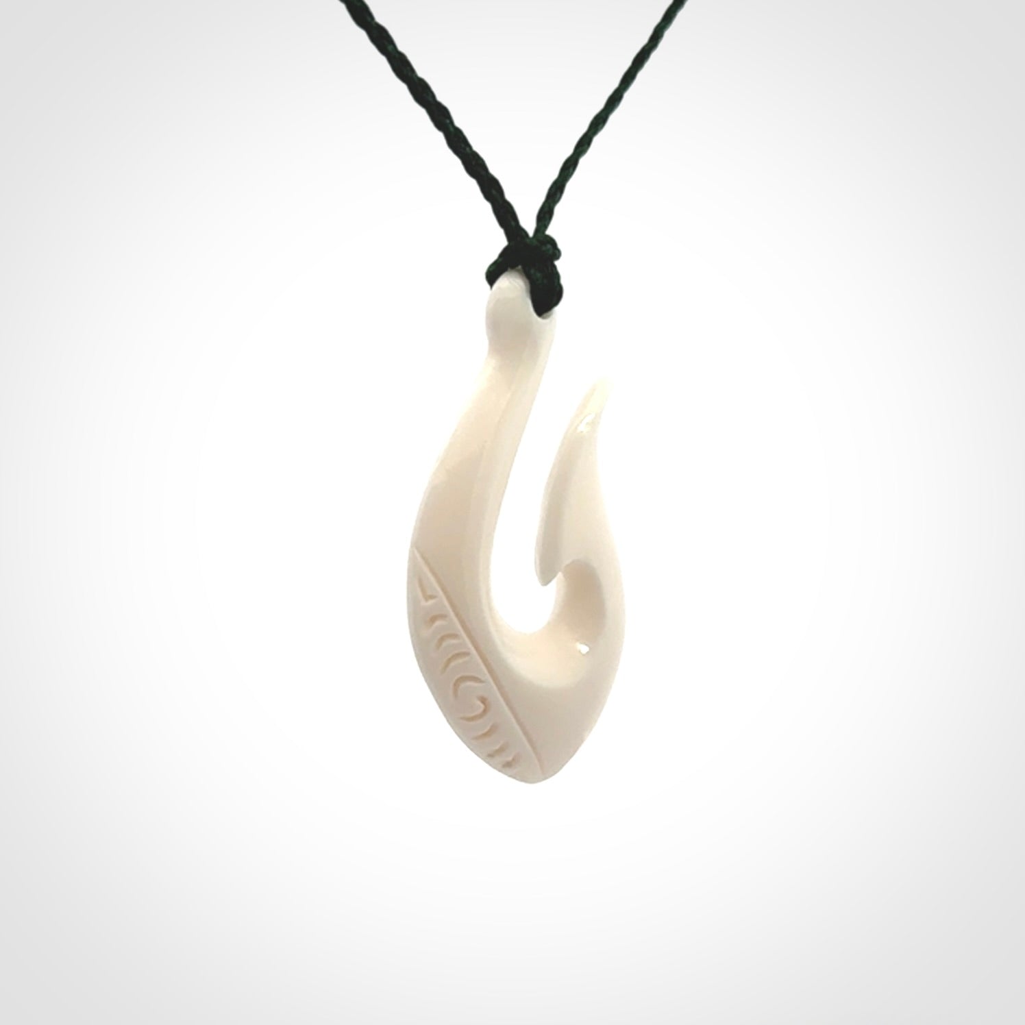 Hand carved bone hook pendants
