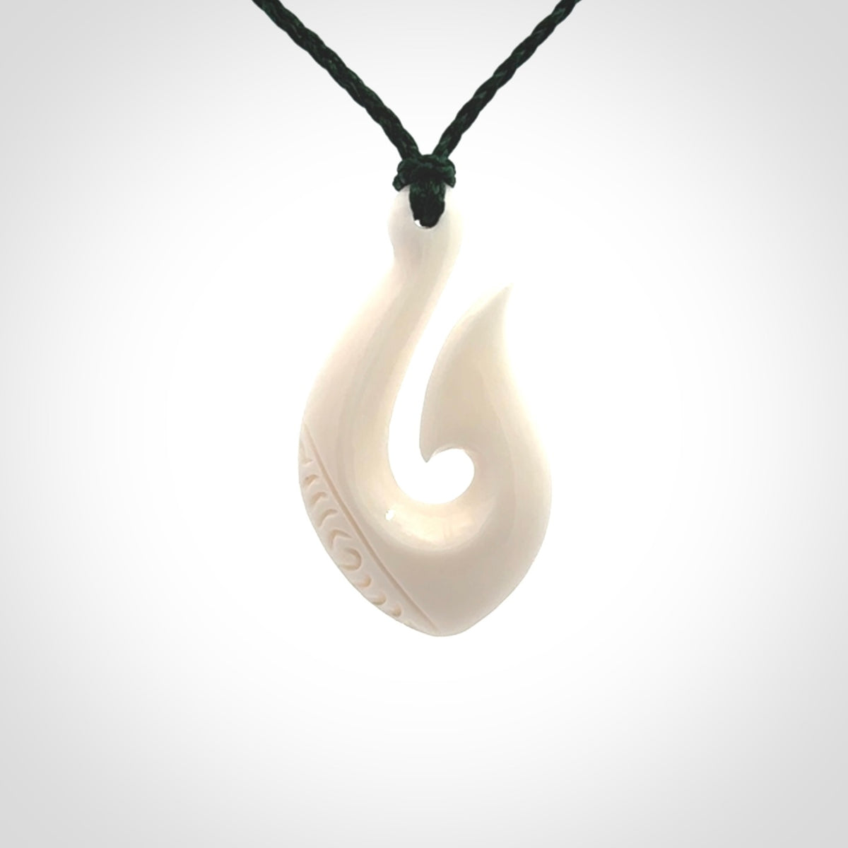 Hand carved bone hook pendants