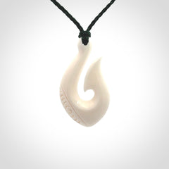 Hand carved bone hook pendants