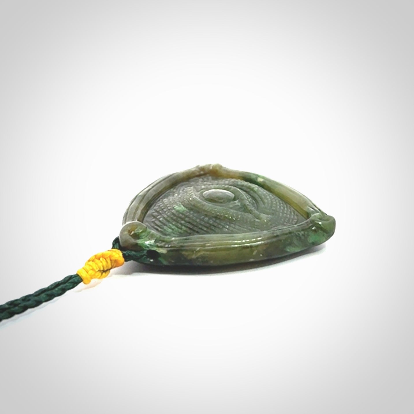 Hand carved contemporary jade third eye pendant. Authentic jade jewellery for sale online. Third eye Jade necklace with adjustable cord.