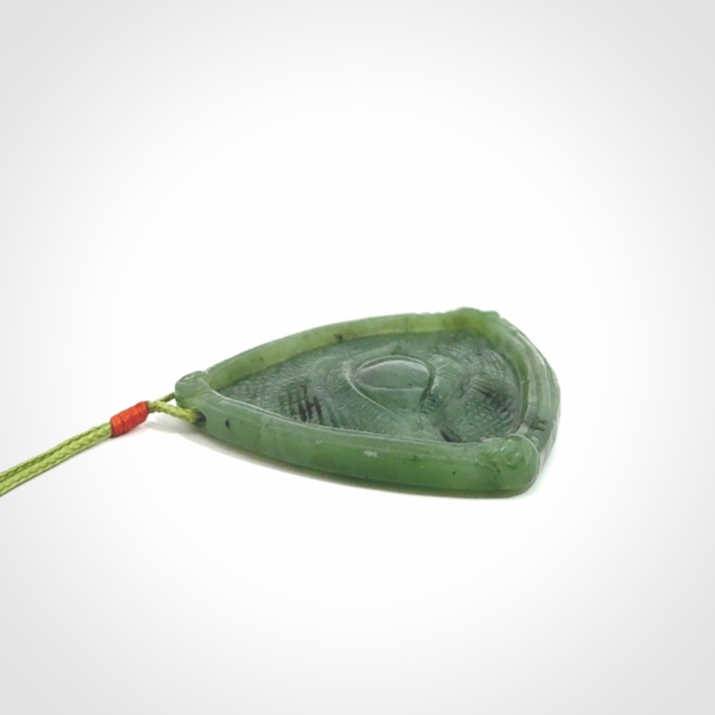 Hand carved contemporary jade third eye pendant. Authentic jade jewellery for sale online. Third eye Jade necklace with adjustable cord.