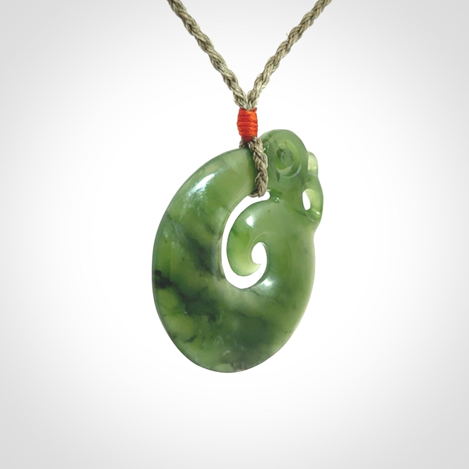 New Zealand Jade Koru Manaia. Hand carved Koropepe pendant. Made in New Zealand. Real Jade, pounamu. Real New Zealand Jade Manaia with Koru necklace with a polished finish.