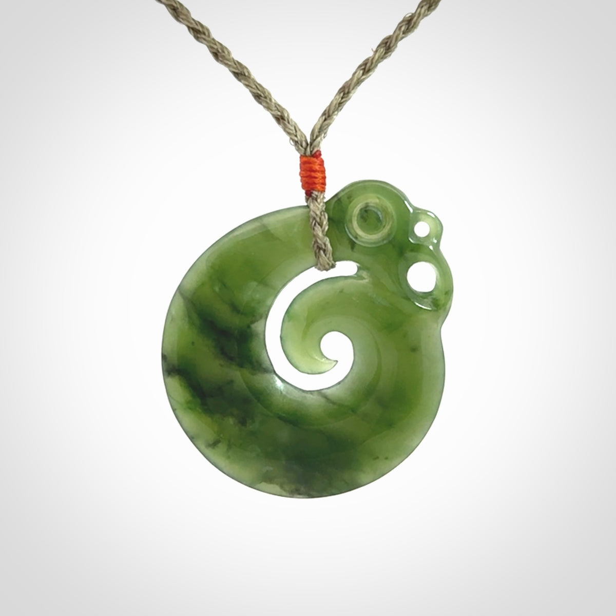 New Zealand Jade Koru Manaia. Hand carved Koropepe pendant. Made in New Zealand. Real Jade, pounamu. Real New Zealand Jade Manaia with Koru necklace with a polished finish.