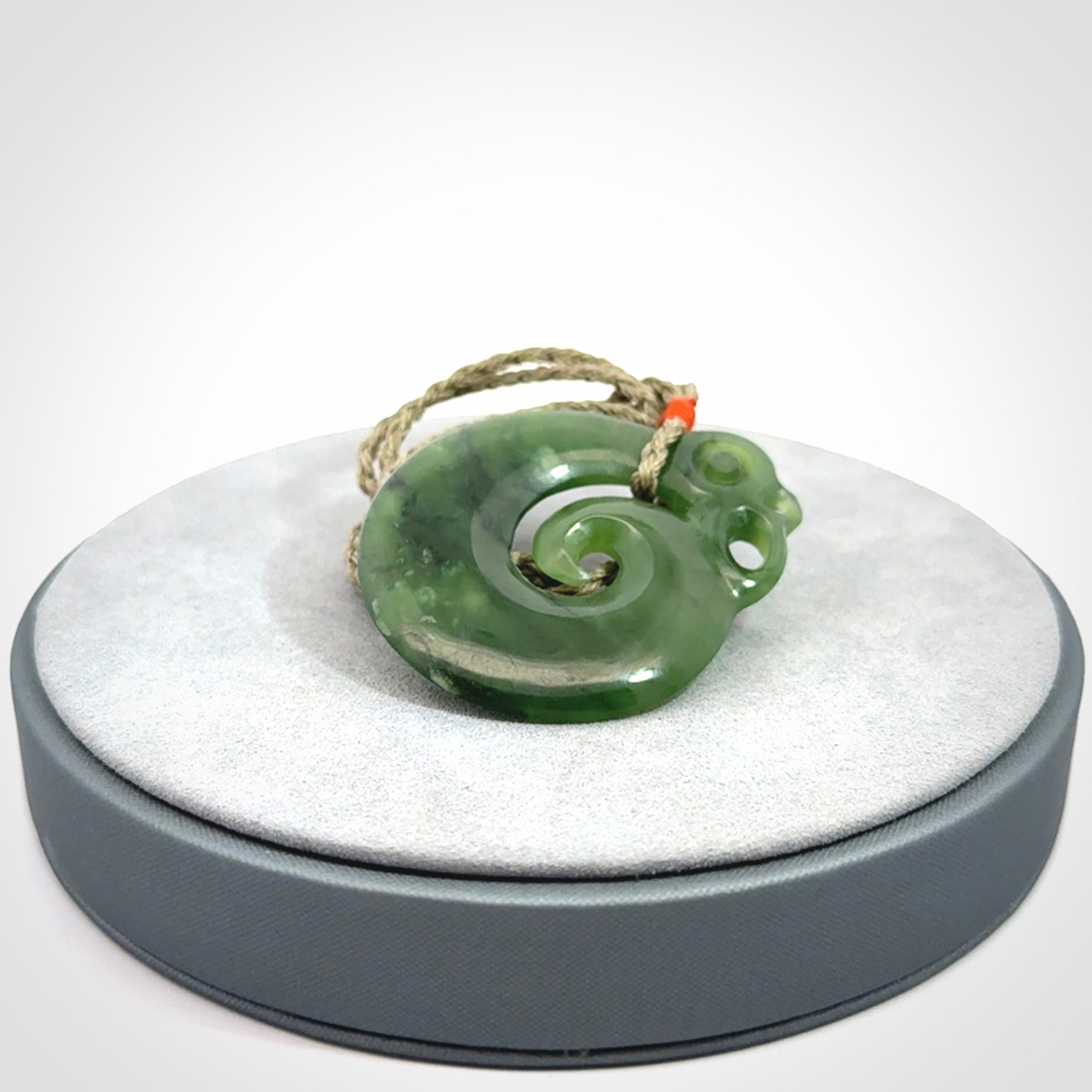 New Zealand Jade Koru Manaia. Hand carved Koropepe pendant. Made in New Zealand. Real Jade, pounamu. Real New Zealand Jade Manaia with Koru necklace with a polished finish.
