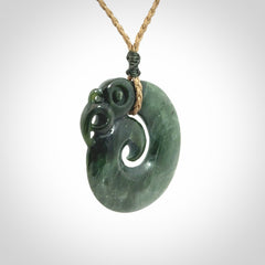 New Zealand Jade Koru Manaia. Hand carved Koropepe pendant. Made in New Zealand. Real Jade, pounamu. Real New Zealand Jade Manaia with Koru necklace with a polished finish.