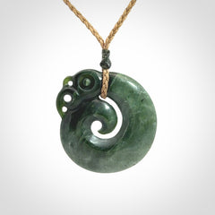 New Zealand Jade Koru Manaia. Hand carved Koropepe pendant. Made in New Zealand. Real Jade, pounamu. Real New Zealand Jade Manaia with Koru necklace with a polished finish.