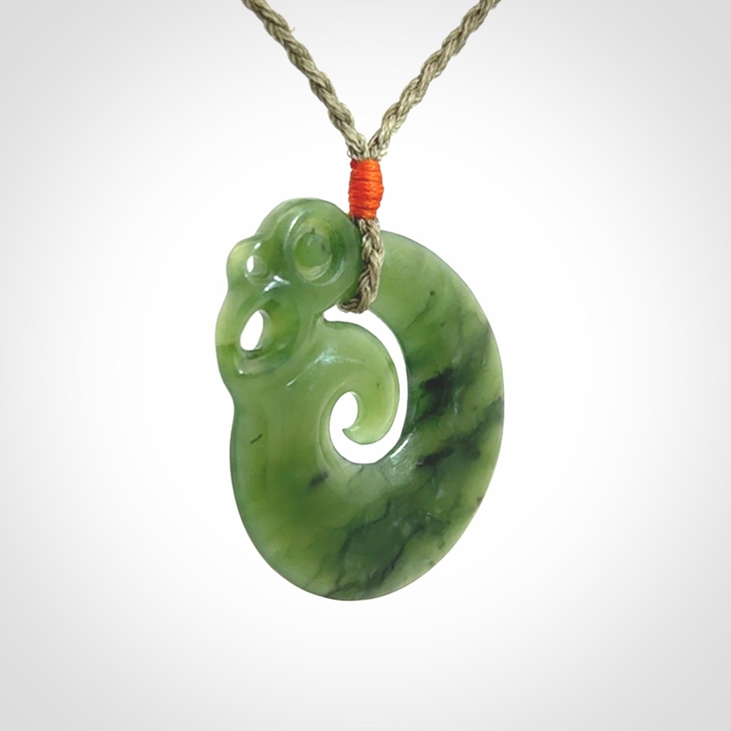 New Zealand Jade Koru Manaia. Hand carved Koropepe pendant. Made in New Zealand. Real Jade, pounamu. Real New Zealand Jade Manaia with Koru necklace with a polished finish.