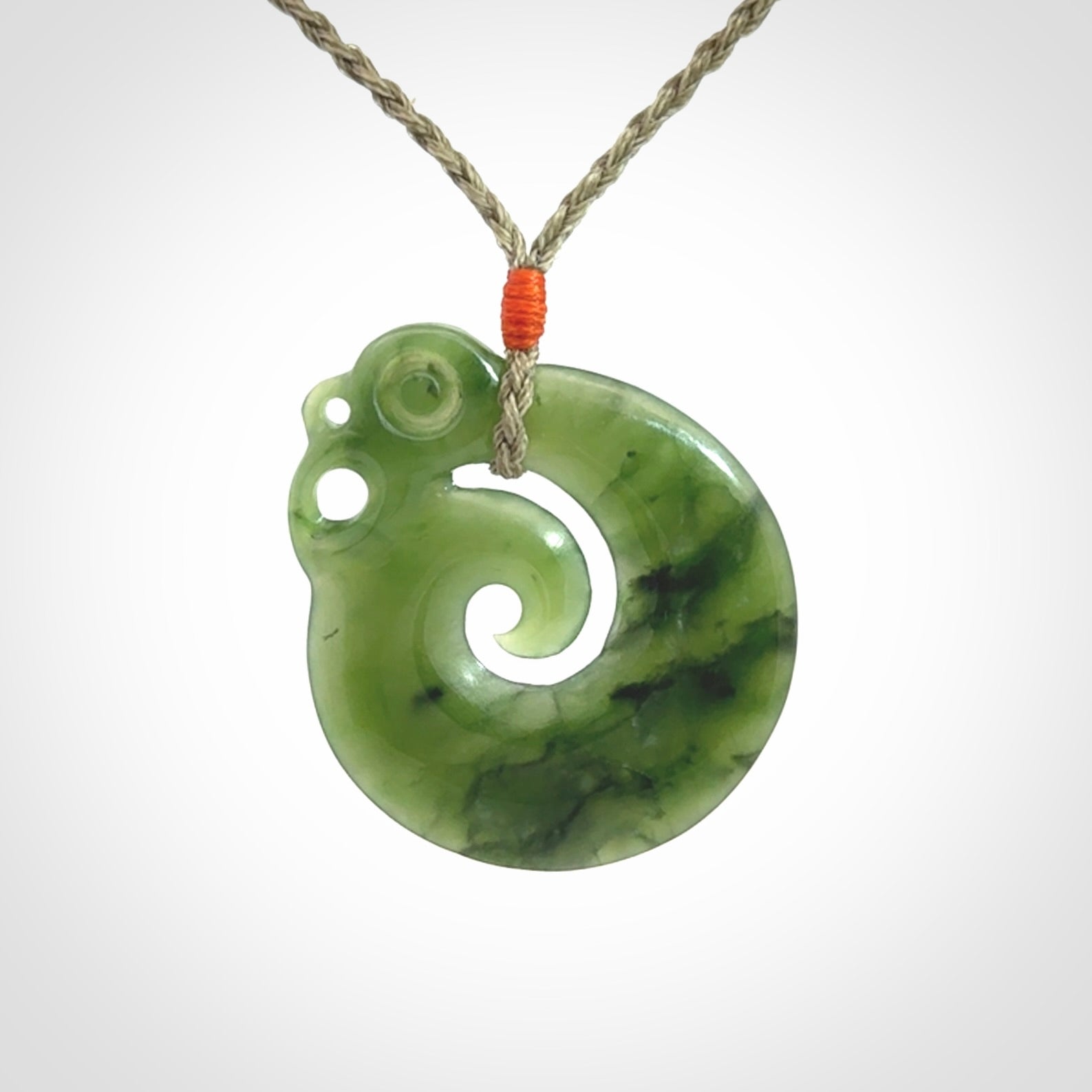 New Zealand Jade Koru Manaia. Hand carved Koropepe pendant. Made in New Zealand. Real Jade, pounamu. Real New Zealand Jade Manaia with Koru necklace with a polished finish.