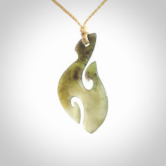 This photo shows a hook with koru pendant carved from New Zealand Jade. We provide this piece with an adjustable oat cord.