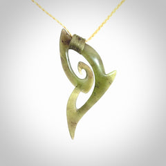 This photo shows a koru pendant carved from New Zealand Jade. We provide this piece with an adjustable oat coloured cord.
