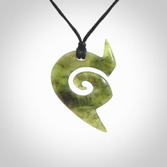 This photo shows a koru pendant carved from New Zealand Jade. The artist, Shaun Gardiner, has carved this beautifully. We provide this piece with an adjustable black cord. This is a fantastic work of art, we have one only.