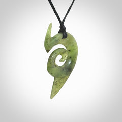 This photo shows a koru pendant carved from New Zealand Jade. The artist, Shaun Gardiner, has carved this beautifully. We provide this piece with an adjustable black cord. This is a fantastic work of art, we have one only.