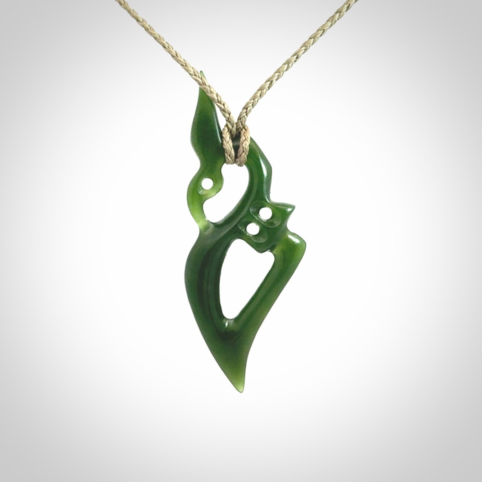 A beautiful hand carved New Zealand Jade Manaia pendant with adjustable cord.