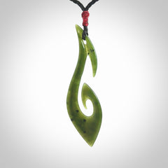 This photo shows a large hook with koru pendant carved from New Zealand Jade. We provide this piece with an adjustable black cord.