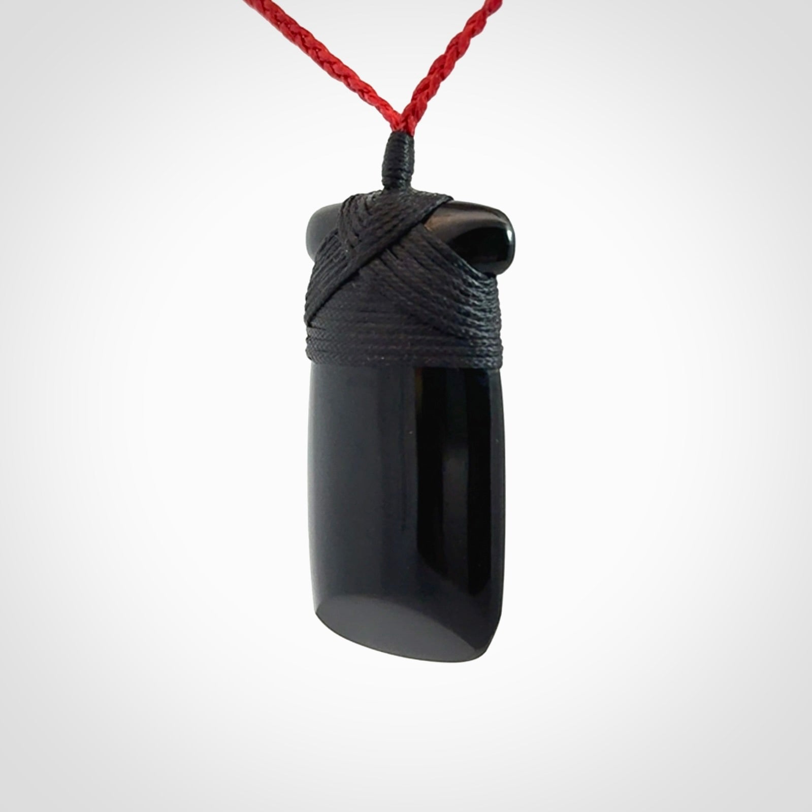 Hand carved black jade toki pendant. Made by NZ Pacific from Australian black jade. Black Jade Toki provided with adjustable cords and packaged in a woven kete pouch. Delivered with express courier.