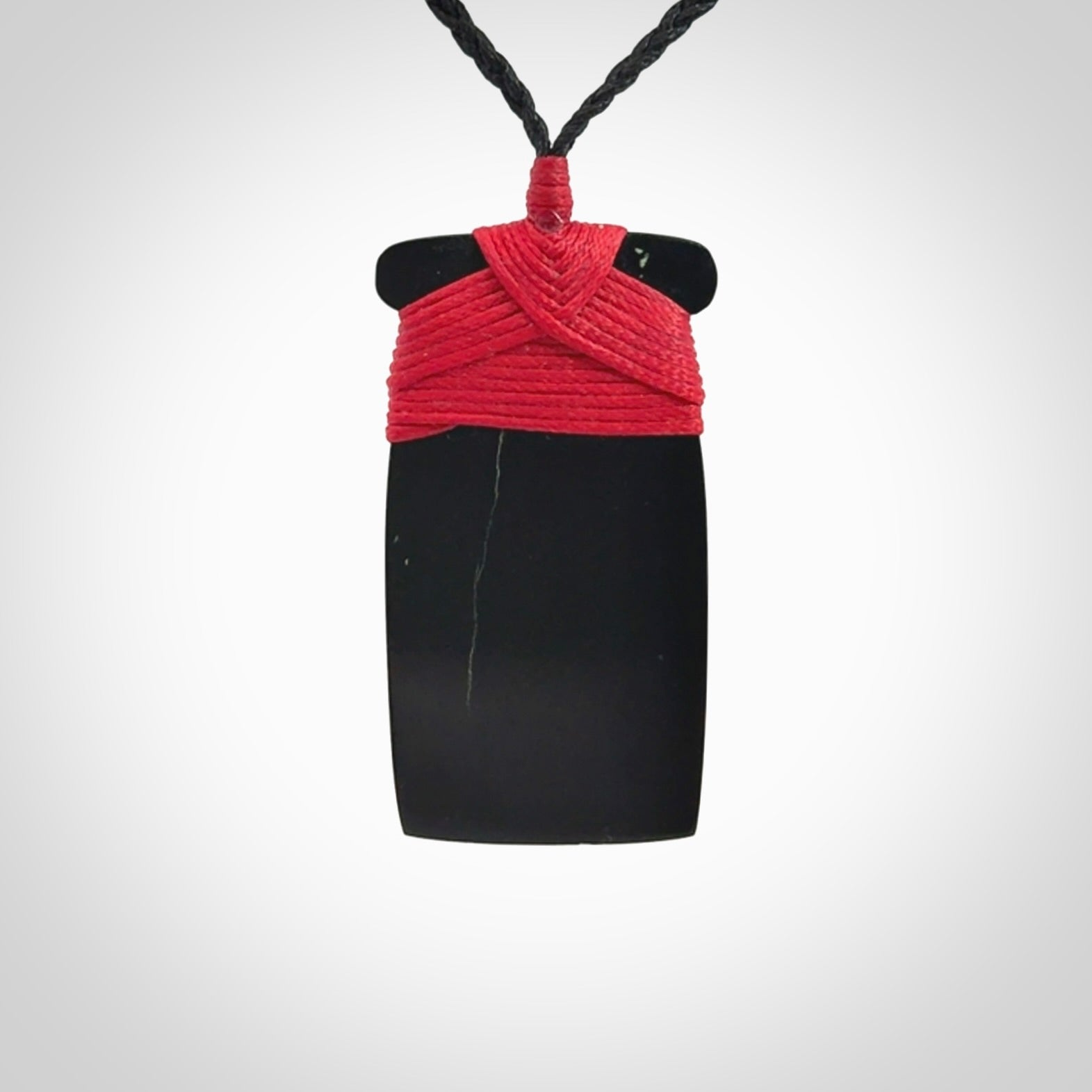 Hand carved black jade toki pendant. Made by NZ Pacific from Australian black jade. Black Jade Toki provided with adjustable cords and packaged in a woven kete pouch. Delivered with express courier.