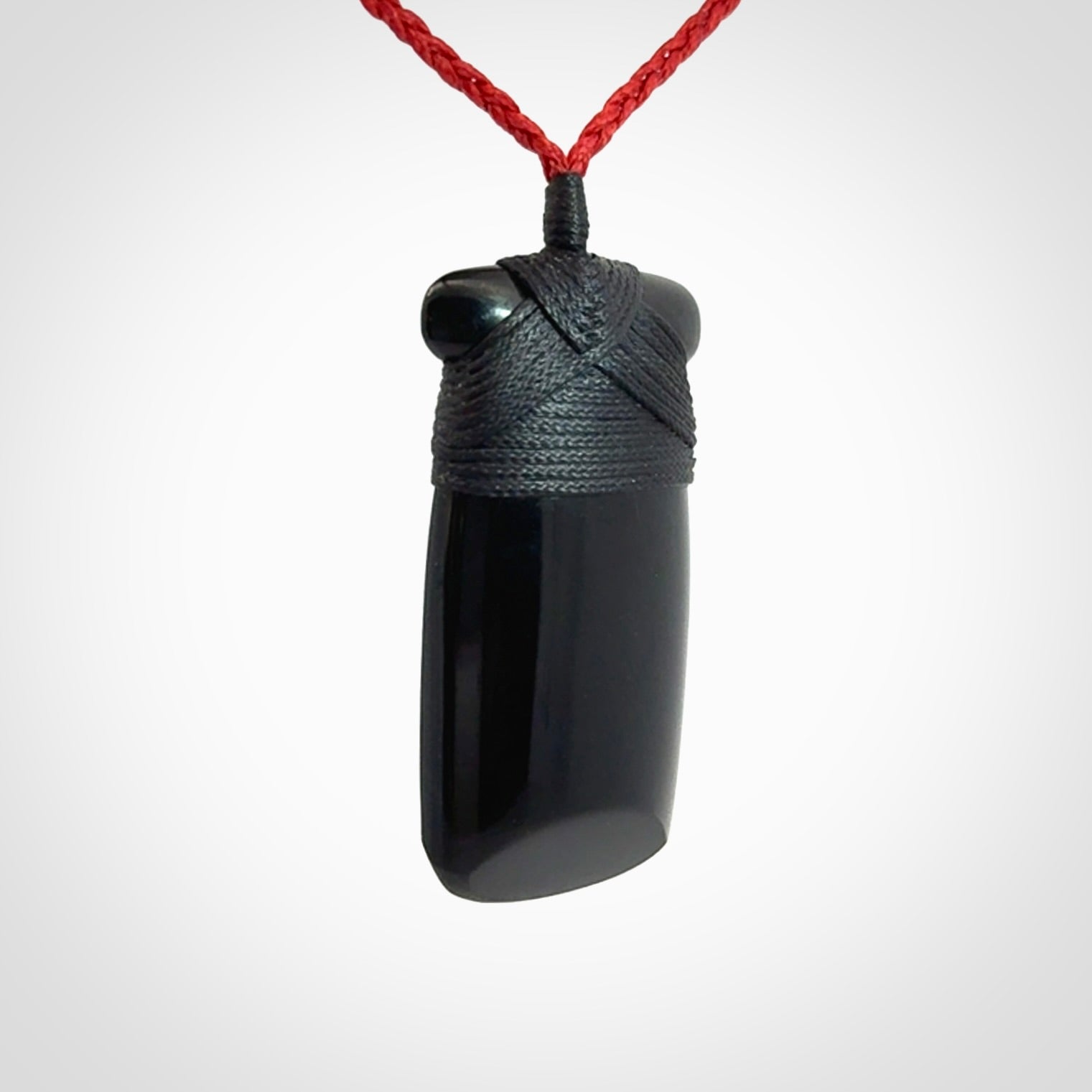 Hand carved black jade toki pendant. Made by NZ Pacific from Australian black jade. Black Jade Toki provided with adjustable cords and packaged in a woven kete pouch. Delivered with express courier.