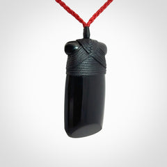 Hand carved black jade toki pendant. Made by NZ Pacific from Australian black jade. Black Jade Toki provided with adjustable cords and packaged in a woven kete pouch. Delivered with express courier.