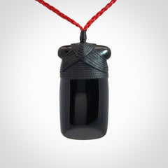 Hand carved black jade toki pendant. Made by NZ Pacific from Australian black jade. Black Jade Toki provided with adjustable cords and packaged in a woven kete pouch. Delivered with express courier.