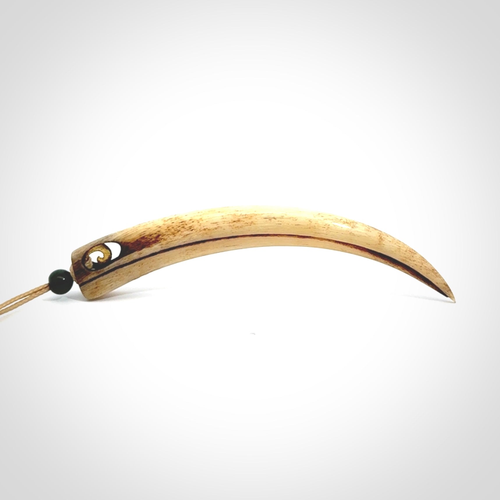 This is a hand carved rams horn huia bird beak pendant. It is made from rams horn with 24 carat gold leaf and jade toggle. This is a large sized necklace and is a very unique, one only, pendant that is a collectors piece. Hand carved by New Zealand artist, Sami.