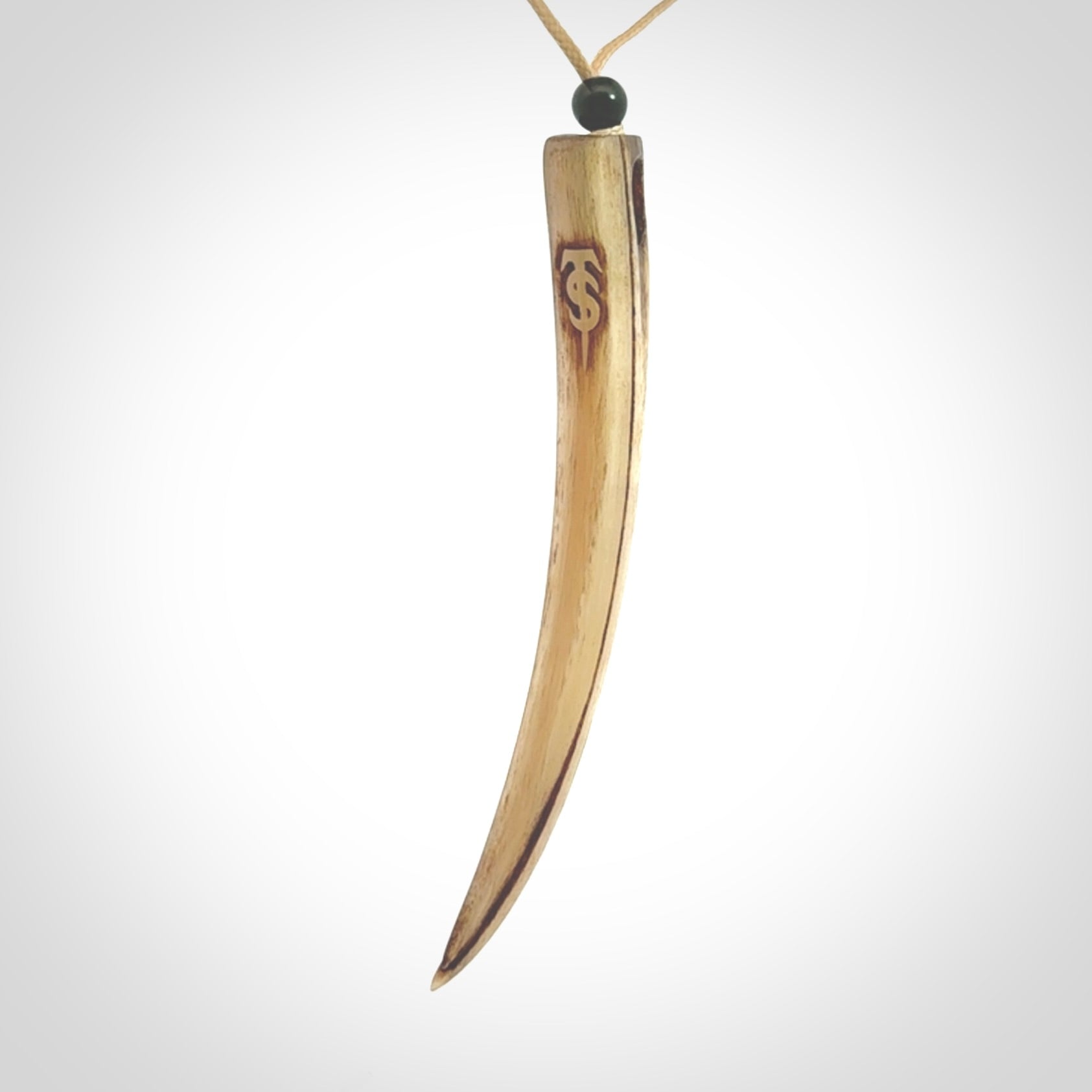 This is a hand carved rams horn huia bird beak pendant. It is made from rams horn with 24 carat gold leaf and jade toggle. This is a large sized necklace and is a very unique, one only, pendant that is a collectors piece. Hand carved by New Zealand artist, Sami.