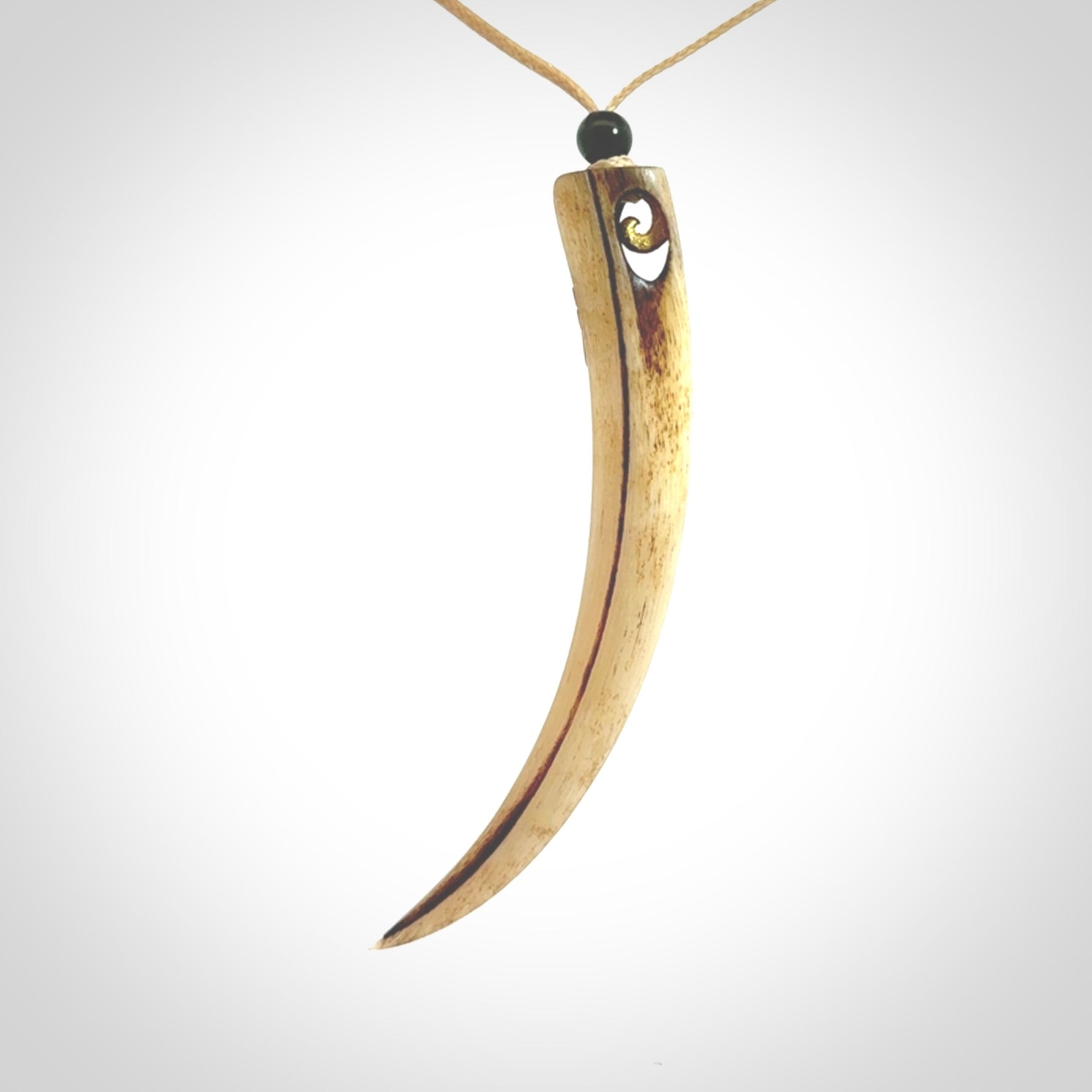 This is a hand carved rams horn huia bird beak pendant. It is made from rams horn with 24 carat gold leaf and jade toggle. This is a large sized necklace and is a very unique, one only, pendant that is a collectors piece. Hand carved by New Zealand artist, Sami.