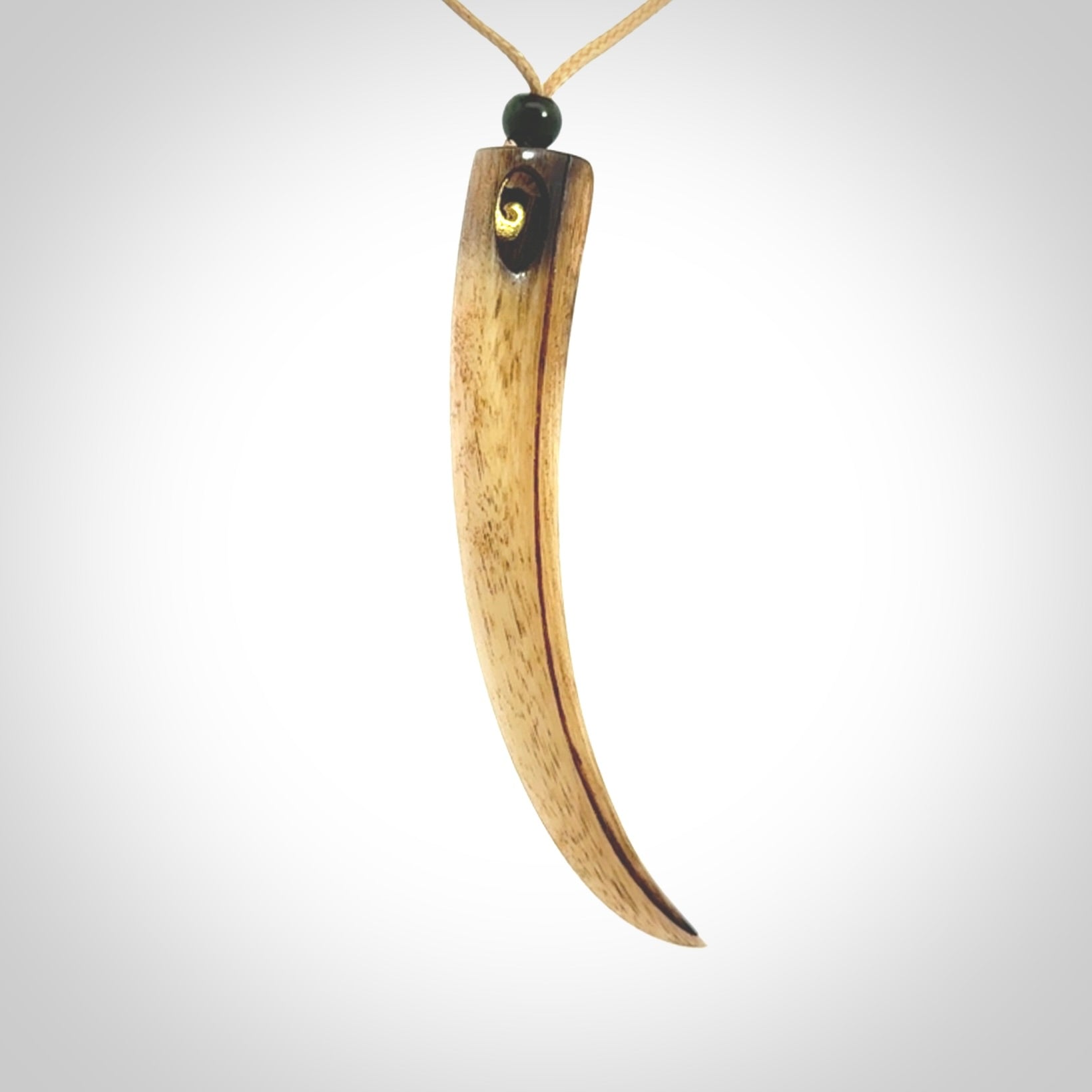 This is a hand carved rams horn huia bird beak pendant. It is made from rams horn with 24 carat gold leaf and jade toggle. This is a large sized necklace and is a very unique, one only, pendant that is a collectors piece. Hand carved by New Zealand artist, Sami.