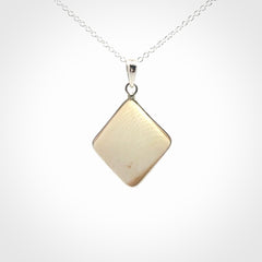Hand carved mammoth tusk pendant. Hand made by NZ Pacific for sale online. Delivered with a sterling silver chain and packaged in a woven kete pouch.