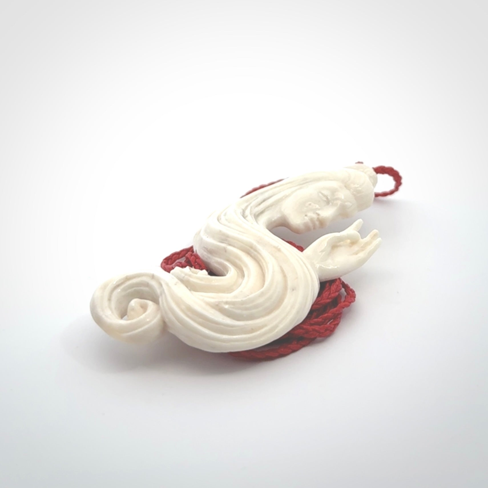This is a contemporary large female pendant carved in bone. Hand carved and provided with an adjustable cord. Woman with shuni mudra hand gesture pendant.