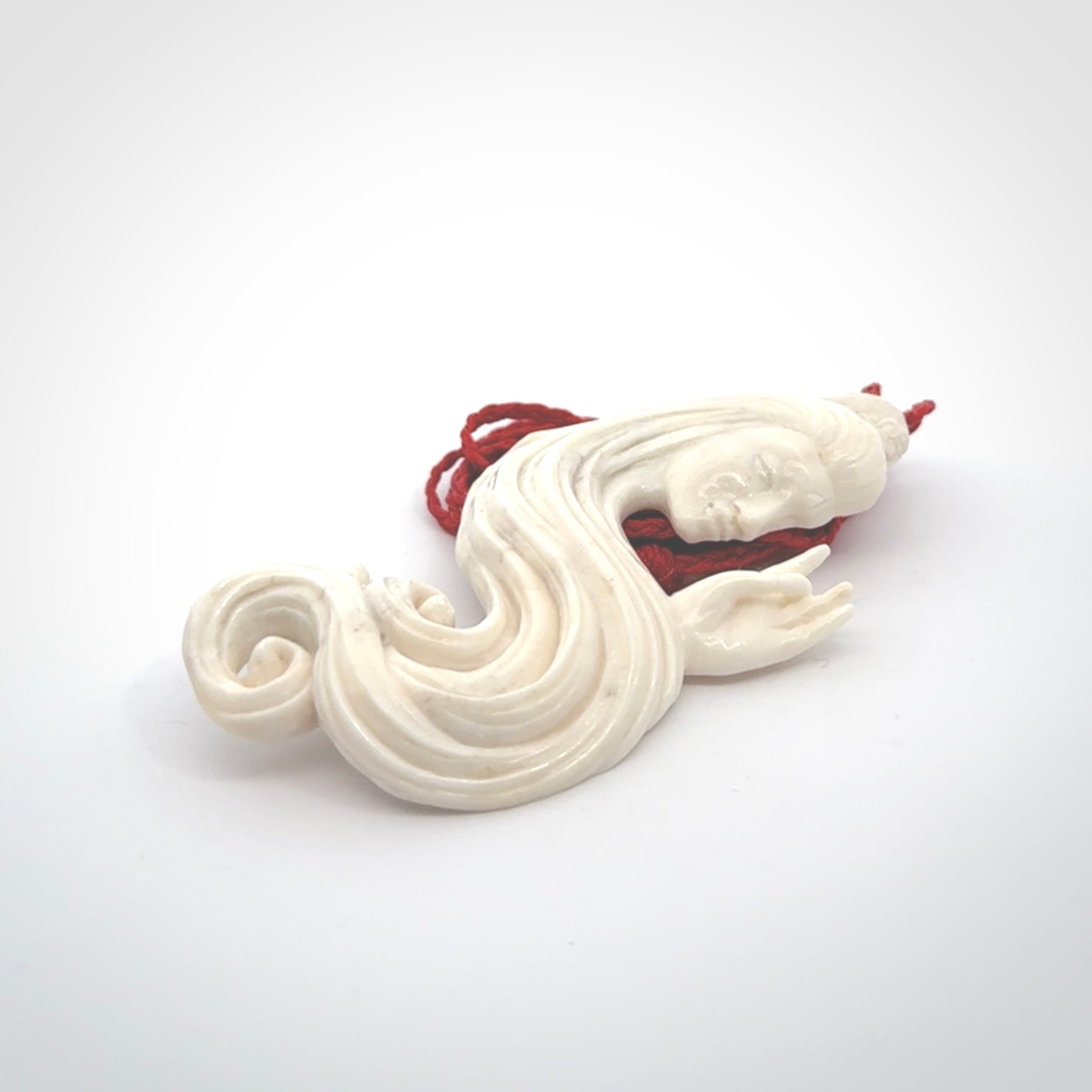 This is a contemporary large female pendant carved in bone. Hand carved and provided with an adjustable cord. Woman with shuni mudra hand gesture pendant.