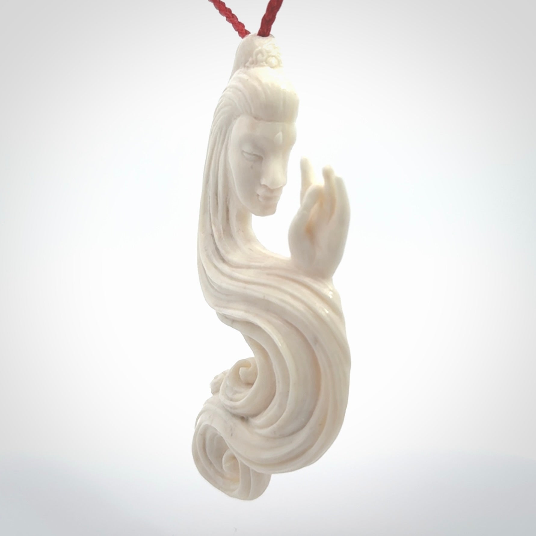This is a contemporary large female pendant carved in bone. Hand carved and provided with an adjustable cord. Woman with shuni mudra hand gesture pendant.