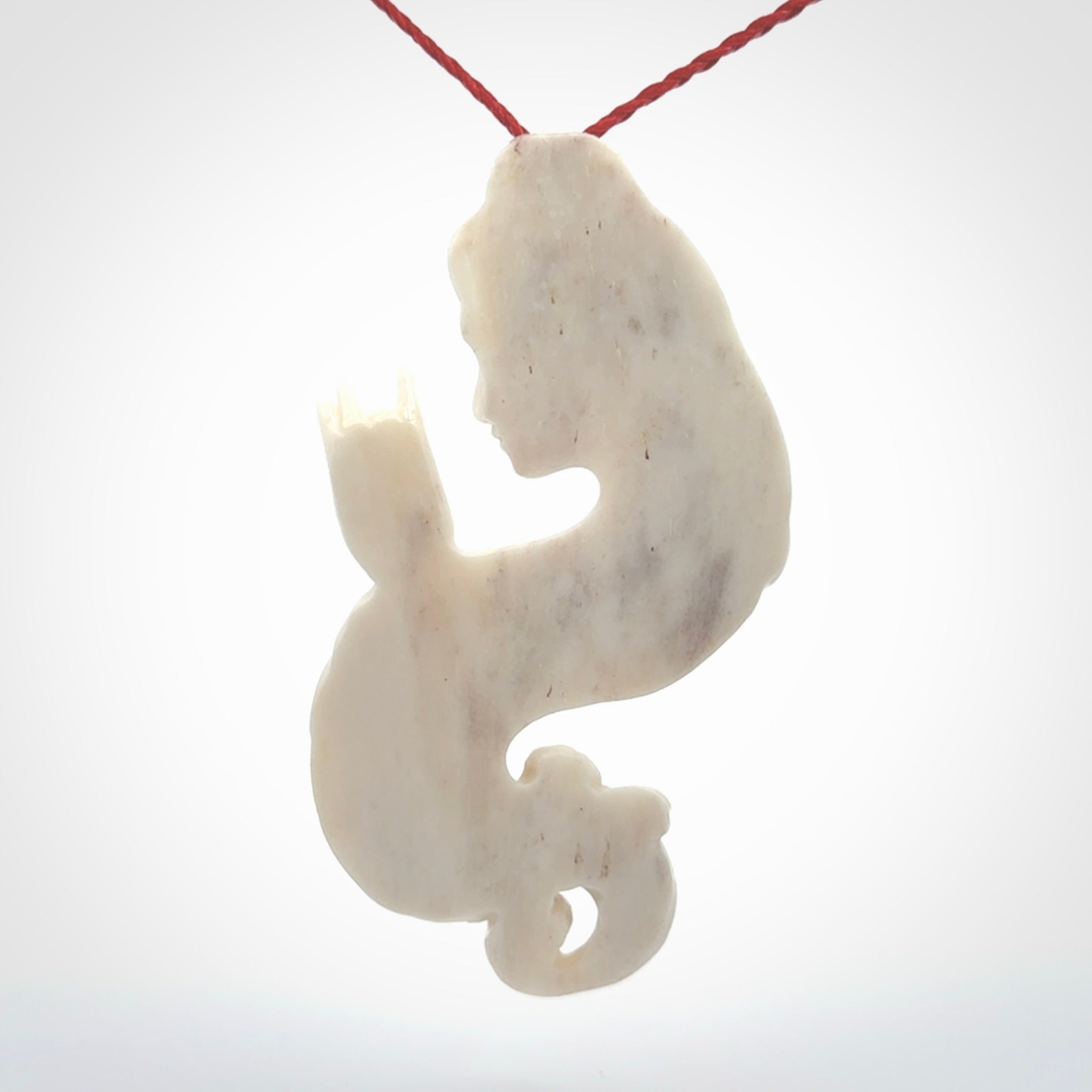 This is a contemporary large female pendant carved in bone. Hand carved and provided with an adjustable cord. Woman with shuni mudra hand gesture pendant.