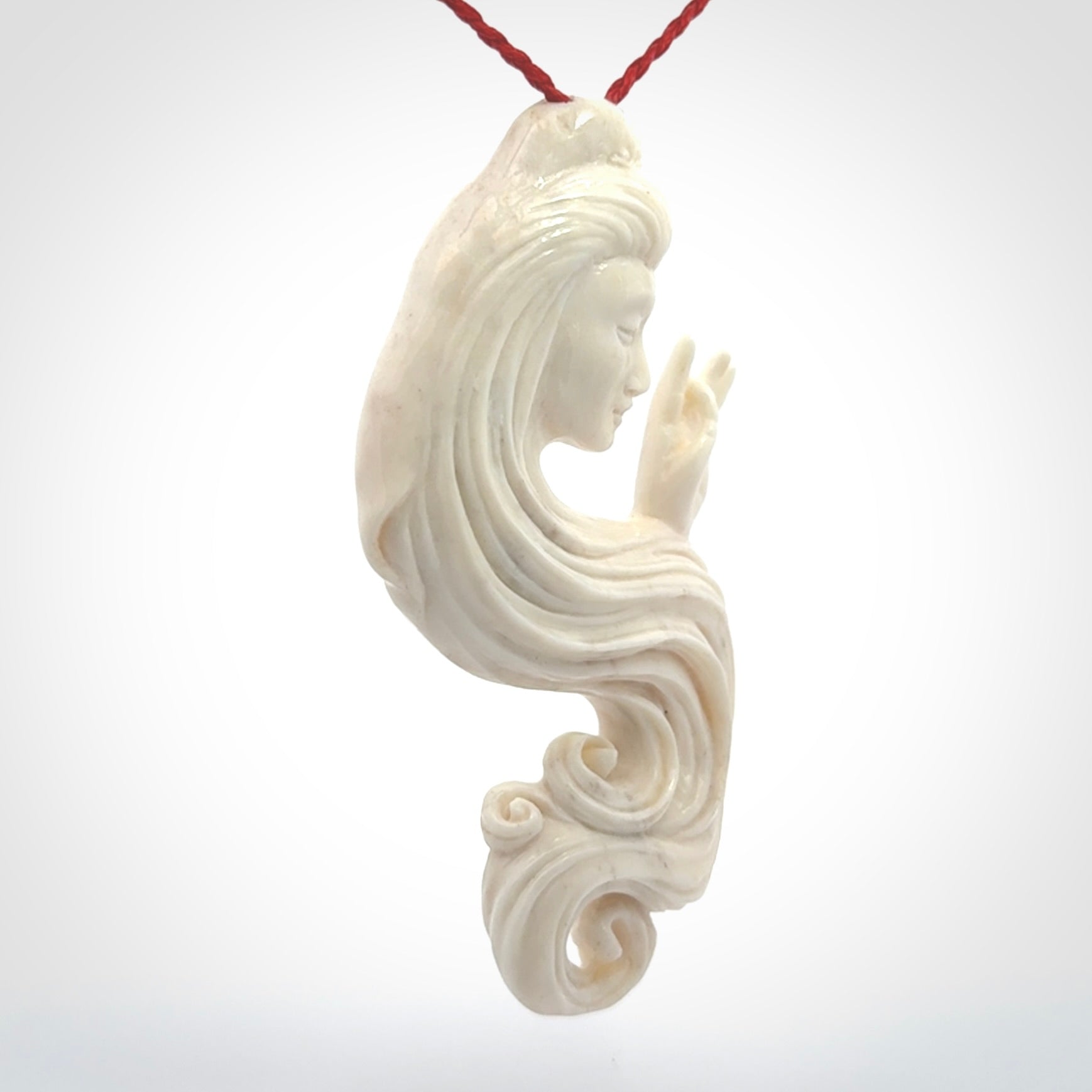 This is a contemporary large female pendant carved in bone. Hand carved and provided with an adjustable cord. Woman with shuni mudra hand gesture pendant.