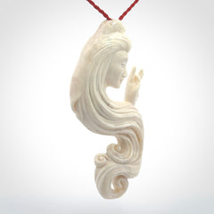This is a contemporary large female pendant carved in bone. Hand carved and provided with an adjustable cord. Woman with shuni mudra hand gesture pendant.