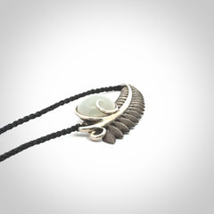 This is a hand carved Sterling Silver Fern leaf pendant with Siberian Jade insert. This is a medium sized necklace and is provided with an adjustable black cord.
