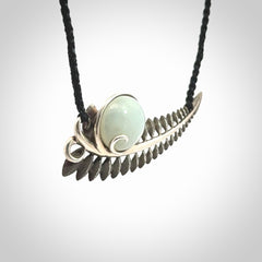 This is a hand carved Sterling Silver Fern leaf pendant with Siberian Jade insert. This is a medium sized necklace and is provided with an adjustable black cord.