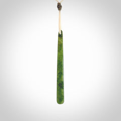 This picture shows a hand carved jade drop pendant by Ric Moor. The jade is a wonderful light, semi-translucent, green. It is suspended from a meringue coloured adjustable cord. Delivery is free worldwide.