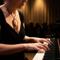 A woman wearing a bone pendant