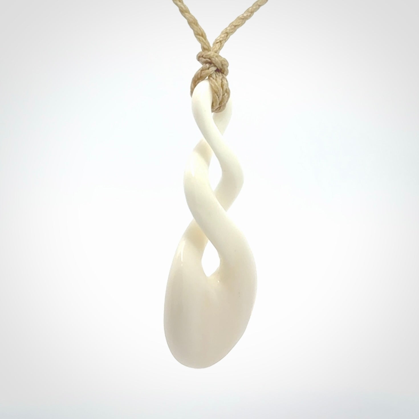 These are very cool, simple double twist pendants carved from natural bone. We have bound these in a adjustable cord and will ship them to you wherever you are. Hand carved by NZ Pacific.