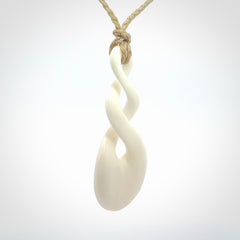 These are very cool, simple double twist pendants carved from natural bone. We have bound these in a adjustable cord and will ship them to you wherever you are. Hand carved by NZ Pacific.