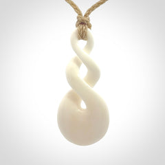 These are very cool, simple double twist pendants carved from natural bone. We have bound these in a adjustable cord and will ship them to you wherever you are. Hand carved by NZ Pacific.