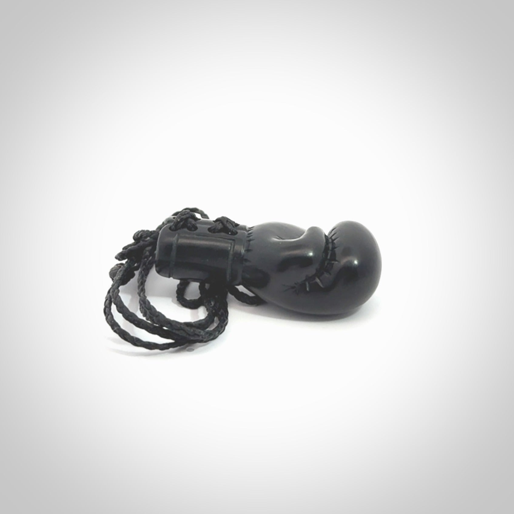 Hand carved boxing glove made from black jade. The cord is adjustable so that you can wear this where it suits you best. We ship these worldwide and the postage is included in the price.